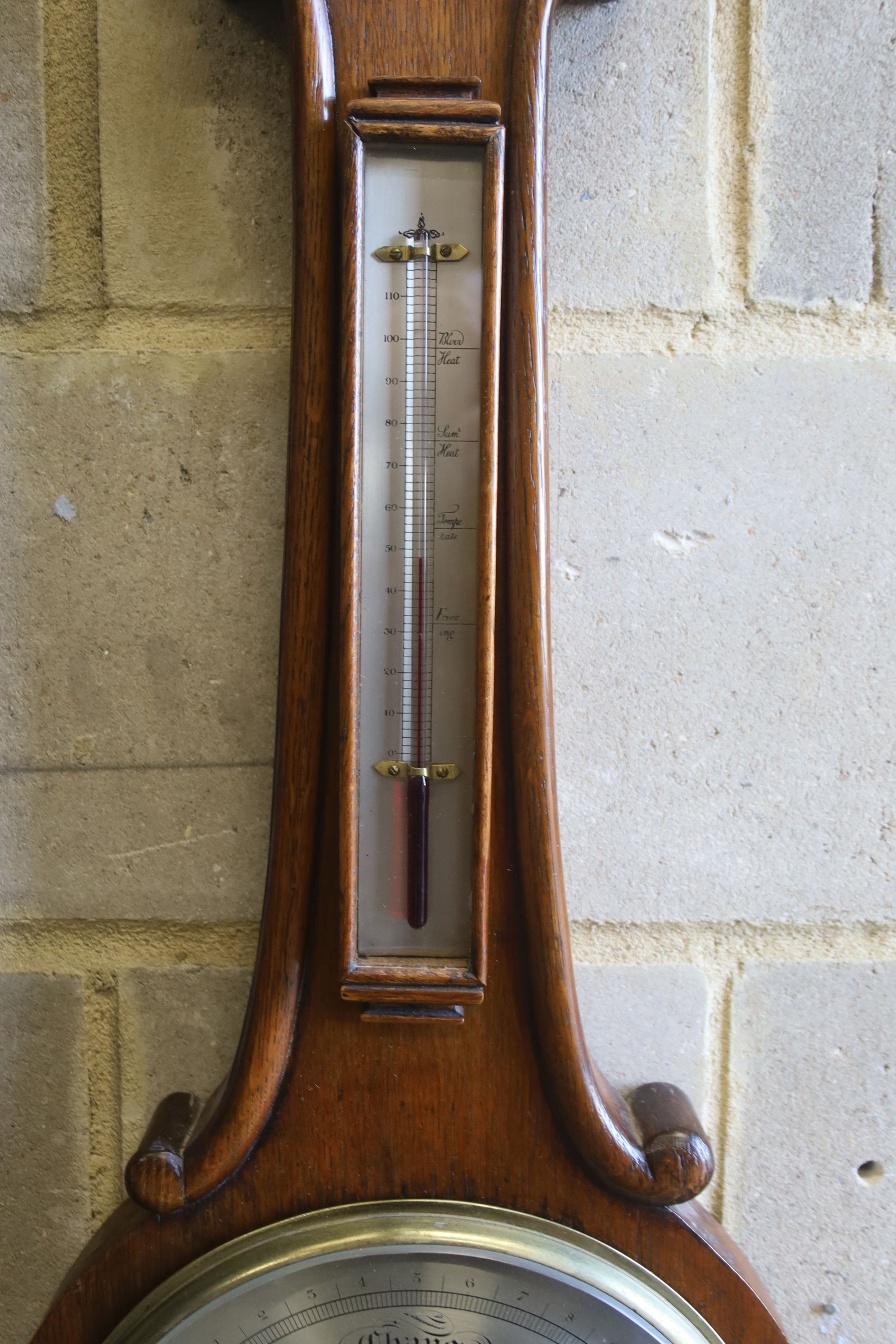 A Victorian oak cased wheel barometer and thermometer by E. Setti, Brooke Street, London, height 102cm